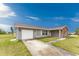 Inviting home featuring a two-car garage, stone accents, and well-kept lawn at 6375 Coniston St, Port Charlotte, FL 33981