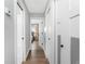 Hallway with hardwood floors leading to a bedroom and bathroom with white doors and neutral walls at 6375 Coniston St, Port Charlotte, FL 33981