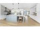 Bright and spacious kitchen featuring a large island with seating, stainless steel appliances, and hardwood floors at 6375 Coniston St, Port Charlotte, FL 33981