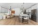Open-concept kitchen and dining area with hardwood floors, stainless steel appliances, and ample natural light at 6375 Coniston St, Port Charlotte, FL 33981