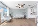 Bright living room with hardwood floors, comfortable seating, and a view of the kitchen area at 6375 Coniston St, Port Charlotte, FL 33981