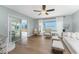 Spacious living room with a ceiling fan and view to the outdoors, creating a seamless transition to the outdoor living space at 6375 Coniston St, Port Charlotte, FL 33981