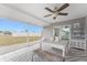 Covered patio features a ceiling fan, tile flooring, and a white dining table with views of the backyard at 6375 Coniston St, Port Charlotte, FL 33981