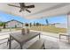 Covered patio with a ceiling fan, dining table, and views of the spacious, fenced backyard at 6375 Coniston St, Port Charlotte, FL 33981