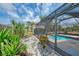 Landscaped backyard with view of pool enclosure, and a small storage shed at 7215 Brookhaven Ter, Englewood, FL 34224
