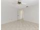 Bedroom with tile flooring, ceiling fan and a partially opened door at 7215 Brookhaven Ter, Englewood, FL 34224