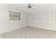 Well-lit bedroom featuring tile floors, a window, and a large closet at 7215 Brookhaven Ter, Englewood, FL 34224