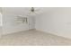 Clean bedroom featuring tile flooring, a window, and a ceiling fan at 7215 Brookhaven Ter, Englewood, FL 34224