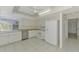 Bright kitchen with white appliances, tile flooring, and ample counter space at 7215 Brookhaven Ter, Englewood, FL 34224