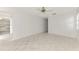 Open living room featuring tile floors, a window, and a ceiling fan at 7215 Brookhaven Ter, Englewood, FL 34224