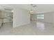 Open concept living and dining area with tile floors, flowing seamlessly into the adjacent kitchen at 7215 Brookhaven Ter, Englewood, FL 34224