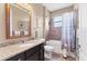Well-lit bathroom featuring granite countertop vanity, toilet, and tiled shower-tub combination with curtain at 758 Rotonda Cir, Rotonda West, FL 33947