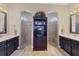 Elegant bathroom featuring dual sinks, vanity, and two separate walk-in showers with a decorative cabinet between at 758 Rotonda Cir, Rotonda West, FL 33947
