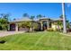 Charming home exterior with a well-manicured lawn, beautiful landscaping, and a two-car garage at 758 Rotonda Cir, Rotonda West, FL 33947