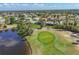 Aerial shot of a golf course near a community with ponds and palm trees creating a picturesque landscape at 758 Rotonda Cir, Rotonda West, FL 33947