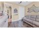 Cozy living room with wood-look floors, reclining sofa, closet, neutral paint, and modern decor at 758 Rotonda Cir, Rotonda West, FL 33947