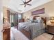 Relaxing main bedroom with tray ceilings, hardwood floors, and an outdoor view at 758 Rotonda Cir, Rotonda West, FL 33947