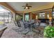 Covered patio offers an outdoor dining area and a view of the pool and the home's interior at 758 Rotonda Cir, Rotonda West, FL 33947