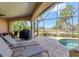 Enjoy the outdoors on the screened-in patio featuring a pool, lounge chairs, and a grill at 758 Rotonda Cir, Rotonda West, FL 33947