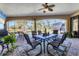 Screened lanai offering an outdoor dining area and comfortable seating with views of the backyard and pool at 758 Rotonda Cir, Rotonda West, FL 33947
