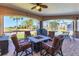 Relaxing outdoor patio with a fire pit and seating overlooks the lush golf course at 758 Rotonda Cir, Rotonda West, FL 33947