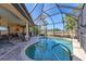 Private pool on a screened-in lanai offers views of the golf course and surrounding nature at 758 Rotonda Cir, Rotonda West, FL 33947