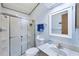 Bright bathroom featuring a glass-enclosed shower, updated vanity, and clean, modern fixtures at 816 Tangerine Woods Blvd, Englewood, FL 34223