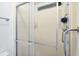 Bathroom featuring a glass-door shower with safety bars and a built-in seat at 816 Tangerine Woods Blvd, Englewood, FL 34223
