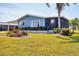Delightful mobile home featuring a carport, screened porch, and a vibrant flower garden at 816 Tangerine Woods Blvd, Englewood, FL 34223