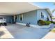 Well-maintained mobile home with a spacious carport, lush greenery, and convenient golf cart parking at 816 Tangerine Woods Blvd, Englewood, FL 34223