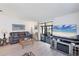 Bright living room with neutral tones, modern flooring, a TV and comfy furniture at 816 Tangerine Woods Blvd, Englewood, FL 34223
