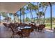 Inviting outdoor seating area with wicker chairs, offering serene water views and a relaxed atmosphere at 816 Tangerine Woods Blvd, Englewood, FL 34223