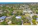 A scenic aerial view captures the home nestled among lush greenery in a tranquil, waterfront community at 850 Van Gogh Road, Englewood, FL 34223