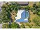 Aerial view showcasing the home with a screened pool and lush, mature landscaping at 850 Van Gogh Road, Englewood, FL 34223
