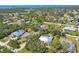 Stunning aerial view of homes with pools surrounded by lush greenery near the coast at 850 Van Gogh Road, Englewood, FL 34223
