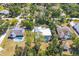 Aerial view of a home with a screened pool in a neighborhood with mature trees at 850 Van Gogh Road, Englewood, FL 34223
