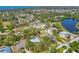A picturesque aerial view shows the home with pool, lush greenery and water views in a coastal community at 850 Van Gogh Road, Englewood, FL 34223
