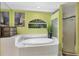 Serene bathroom featuring a soaking tub, glass-enclosed shower, and natural light at 850 Van Gogh Road, Englewood, FL 34223