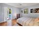 Inviting bedroom with a door opening to a patio near the pool at 850 Van Gogh Road, Englewood, FL 34223