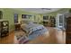 Bright bedroom with hardwood floors, natural light, and a door to the outdoor pool at 850 Van Gogh Road, Englewood, FL 34223