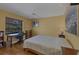 Cozy bedroom with a ceiling fan, a desk area, and a window with a backyard view at 850 Van Gogh Road, Englewood, FL 34223
