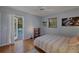 Tranquil bedroom with a view of the pool, access to the backyard, and comfortable décor at 850 Van Gogh Road, Englewood, FL 34223