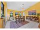 Cozy dining room featuring a wooden table set and colorful rug on white tile at 850 Van Gogh Road, Englewood, FL 34223