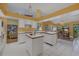 Open-concept kitchen with white cabinetry, stainless steel appliances, and a clear view into the living room at 850 Van Gogh Road, Englewood, FL 34223