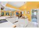 Spacious kitchen with white cabinetry, tile flooring, and island, featuring yellow walls at 850 Van Gogh Road, Englewood, FL 34223