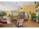 Cozy living room with soaring ceiling, tropical decor, and seating at 850 Van Gogh Road, Englewood, FL 34223