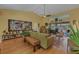 Bright living room with high ceilings, large colorful art piece and view of the pool area at 850 Van Gogh Road, Englewood, FL 34223