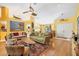 This living room features bright walls, an accent rug, unique seating and a ceiling fan at 850 Van Gogh Road, Englewood, FL 34223