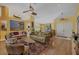 Bright living room with vaulted ceilings, comfortable seating, and a view of the front entryway at 850 Van Gogh Road, Englewood, FL 34223