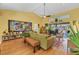 This bright living room features an abundance of natural light, wood floors and an accent rug at 850 Van Gogh Road, Englewood, FL 34223